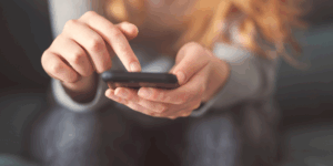 woman's hands holding a phone