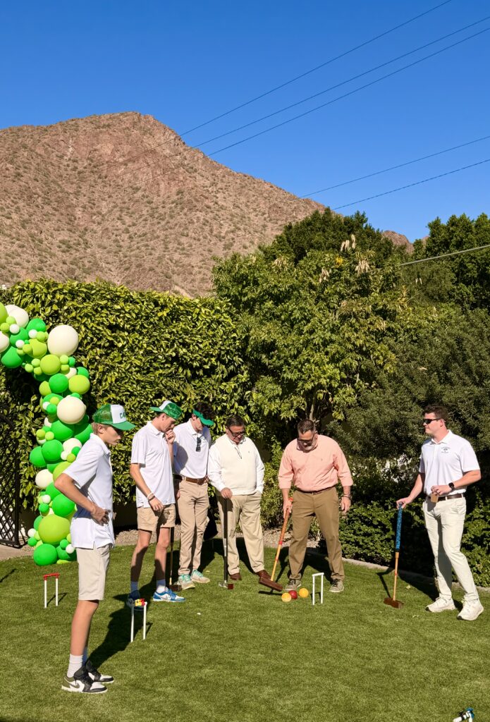 Group of men playing croquet