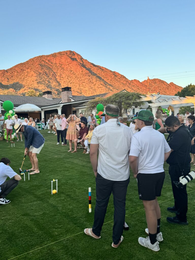 View of two men from teh back with the mountain in the background