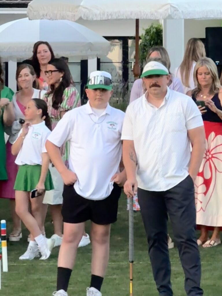 Two man wearing a white tshirt and cap